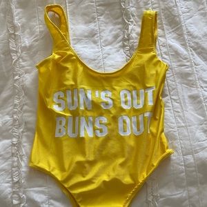 One piece bathing suit. “Suns out buns out”